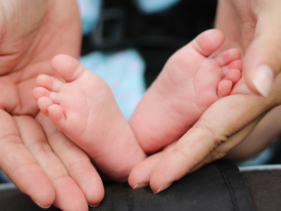 person holding a baby's feet