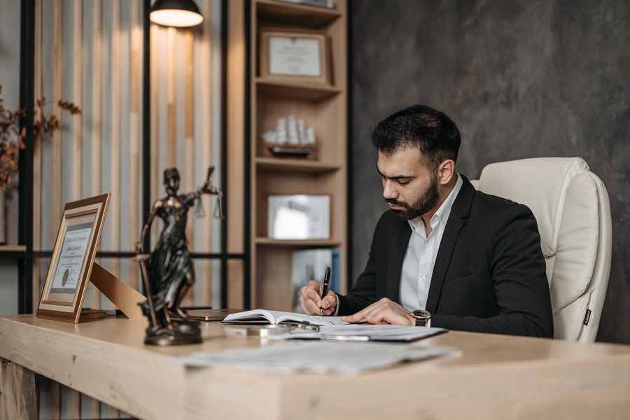professional Lawyer writing on a Notebook