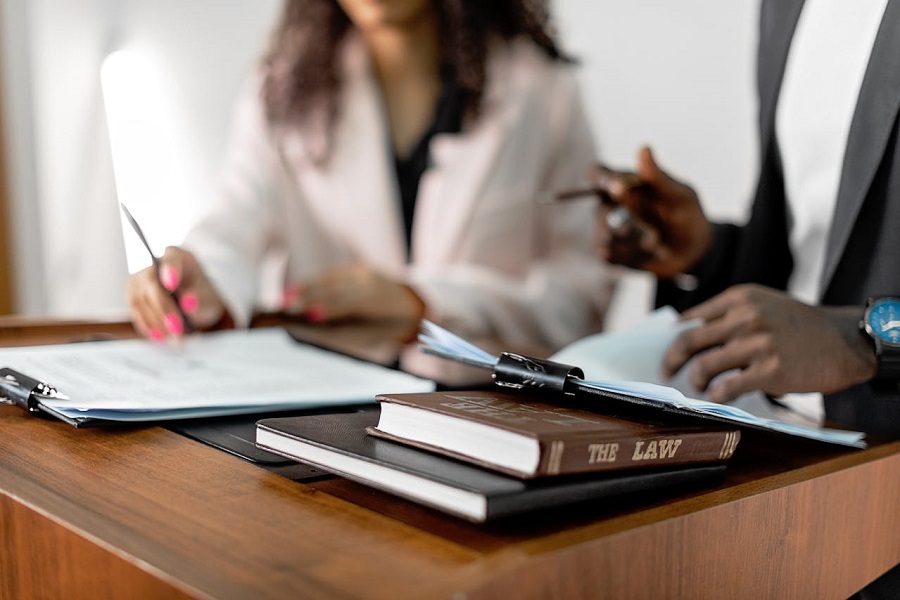 Lawyer working at desk with law book on the table