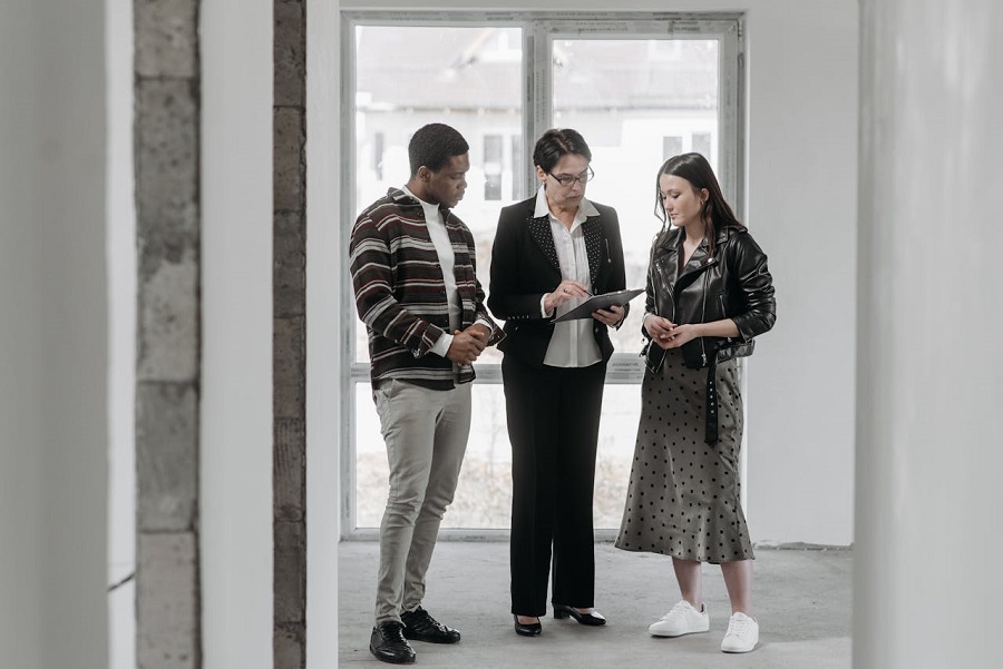 Man and Woman Talking with Real Estate Agent