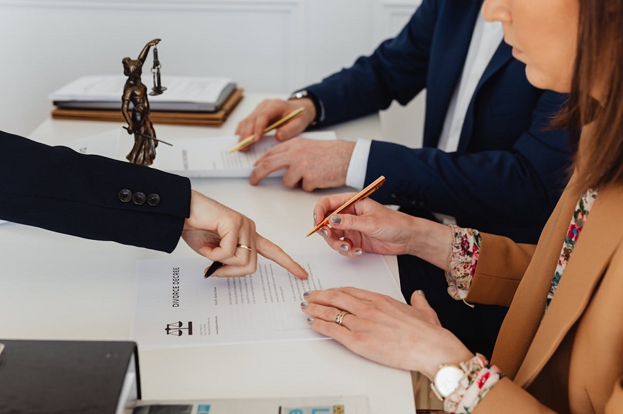Woman Signing a divorce Decree
