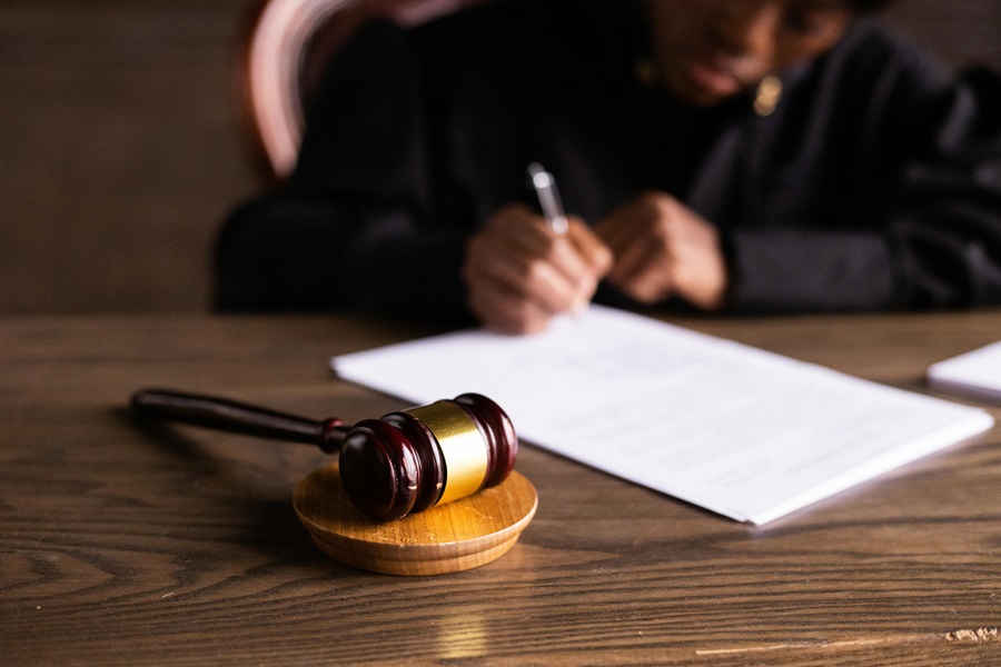 A Small Claims Court judge signing a document.