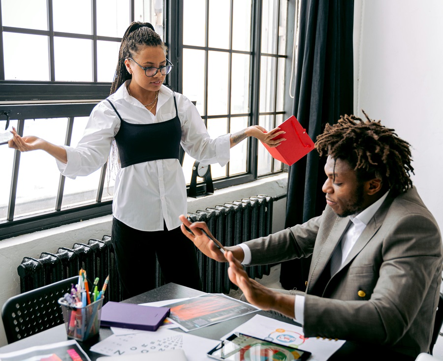 Female employee being dismissed by her male manager in a office