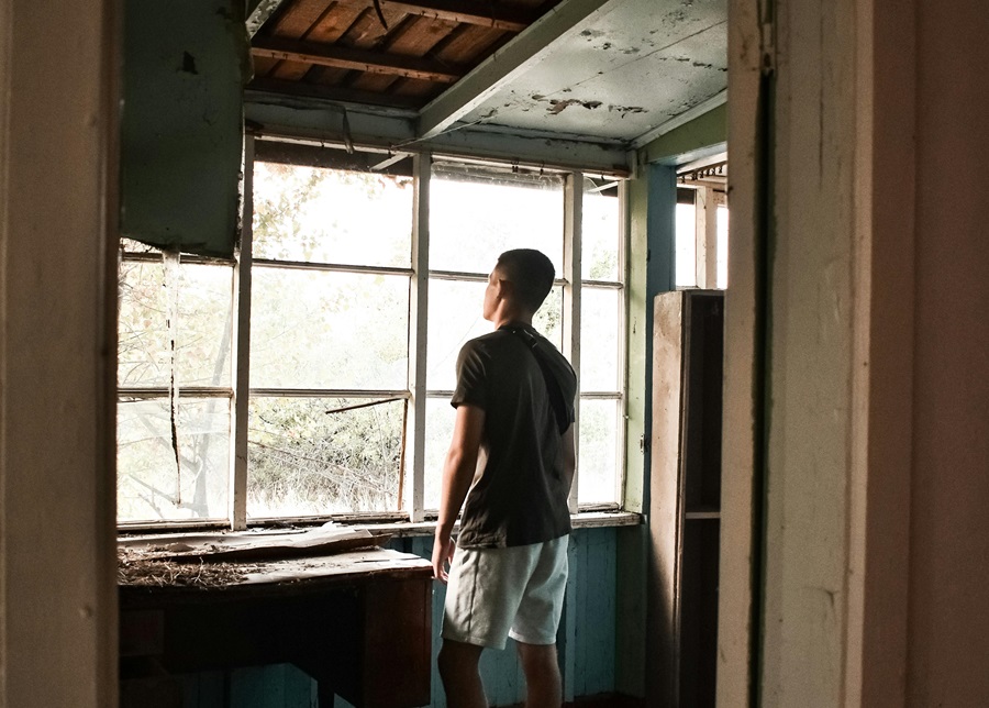 A man looking at damaged building interior linked to latent construction defects