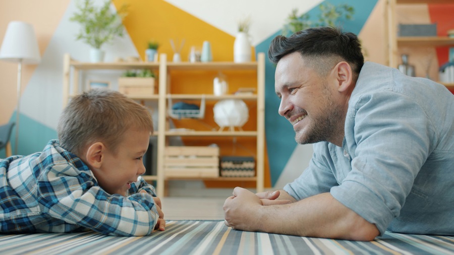 Father and young child talking at home, illustrating parental responsibility and a parent’s role in a child’s upbringing in the UK
