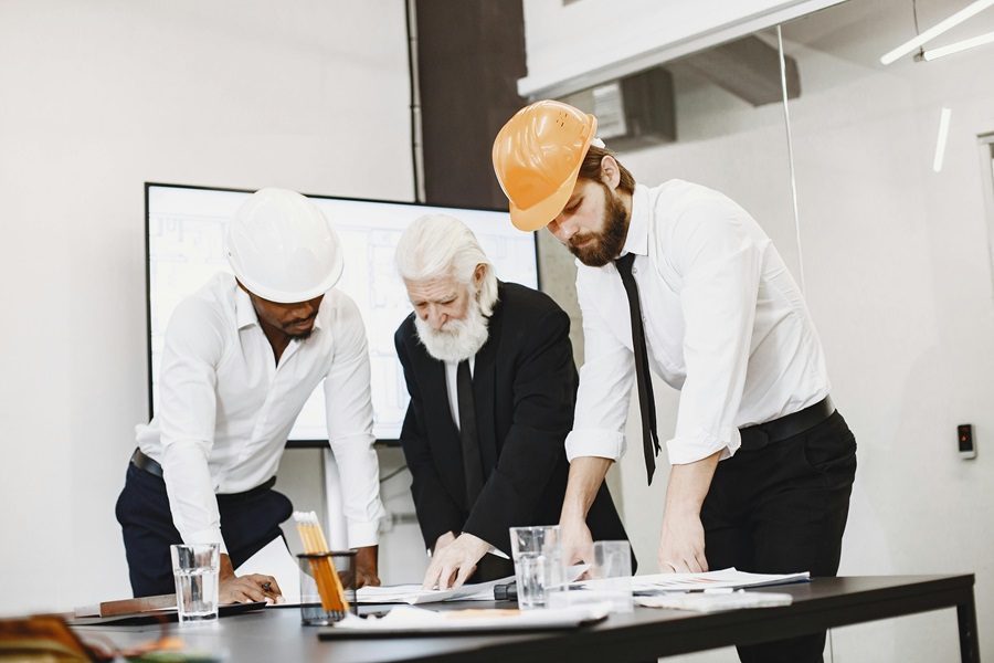 Construction professionals reviewing contract documents with a solicitor during a payment dispute