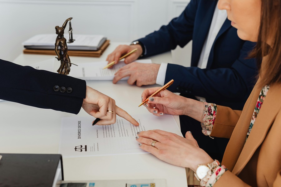 Divorce settlement discussion with solicitor reviewing financial agreement documents